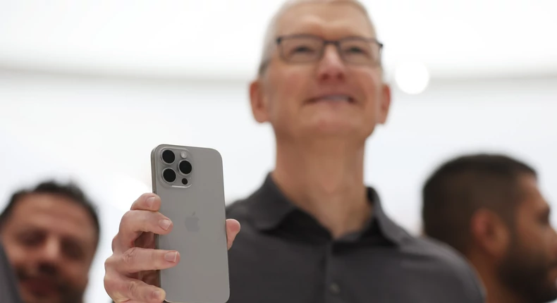 Apple CEO Tim Cook photographed holding the new titanium iPhone 15 Pro on Tuesday. Cook also acted in a surprise skit opposite Octavia Spencer.Justin Sullivan/Getty Images